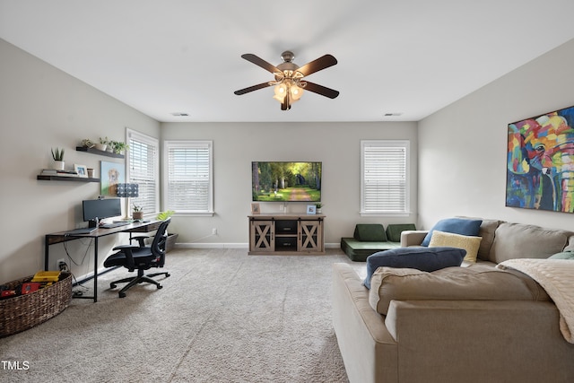 carpeted home office with visible vents, ceiling fan, and baseboards