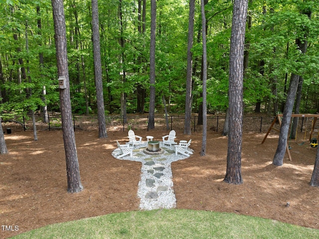 view of yard with fence and an outdoor fire pit