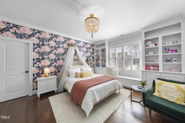 bedroom with wallpapered walls, crown molding, wood finished floors, and a chandelier