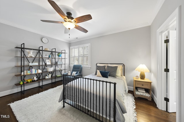 bedroom with baseboards, wood finished floors, and crown molding