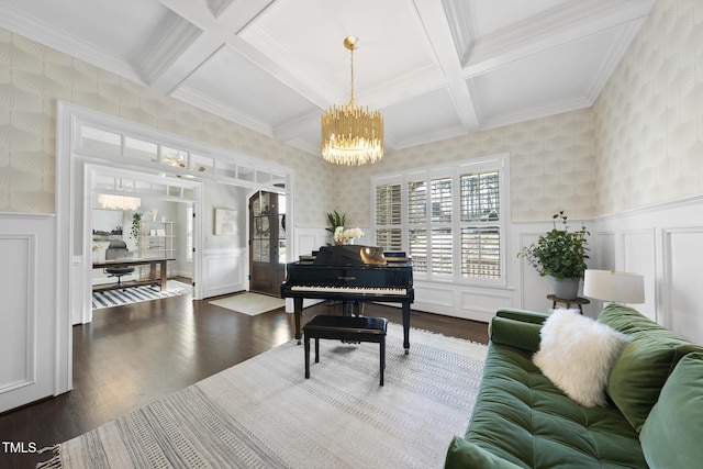 living room featuring beam ceiling, dark wood-style flooring, wainscoting, and wallpapered walls