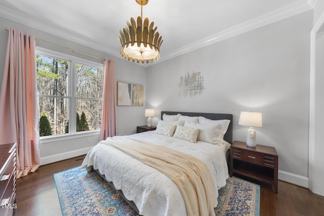 bedroom featuring wood finished floors, baseboards, multiple windows, and ornamental molding