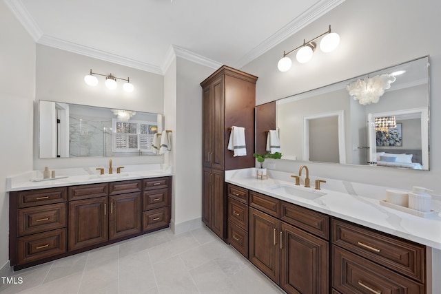 full bath with a stall shower, crown molding, and a sink