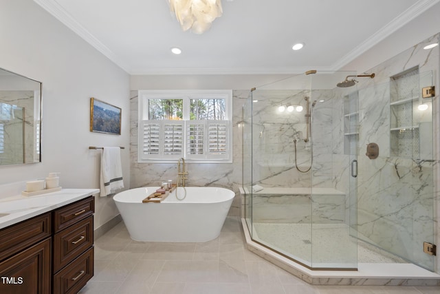 bathroom featuring a marble finish shower, a freestanding bath, ornamental molding, and vanity