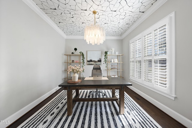 interior space with wood finished floors, baseboards, a notable chandelier, and ornamental molding