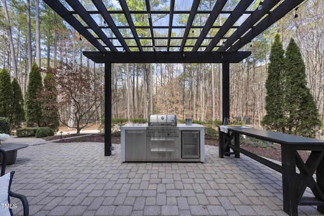 view of patio / terrace with a view of trees and a pergola