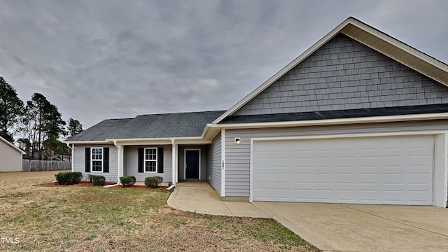 single story home with a front yard, an attached garage, driveway, and fence