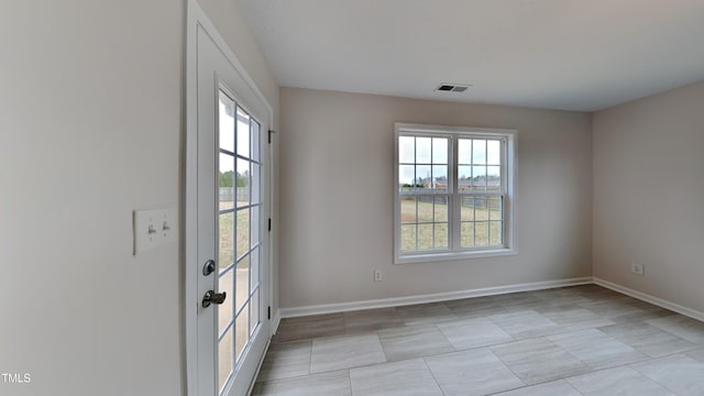 empty room with baseboards and visible vents