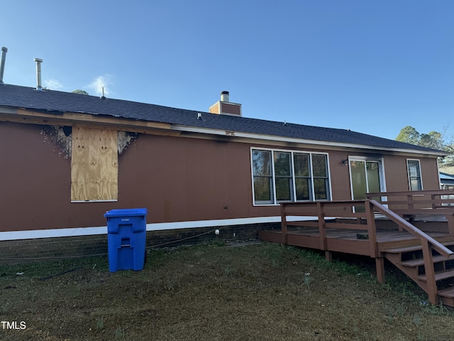 back of house with a deck and a chimney