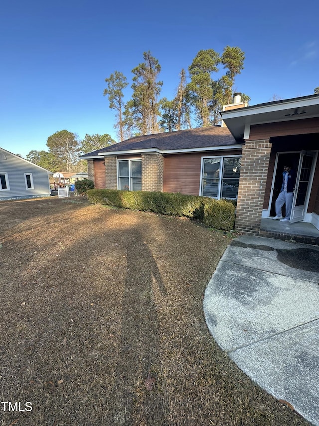 view of side of property featuring brick siding