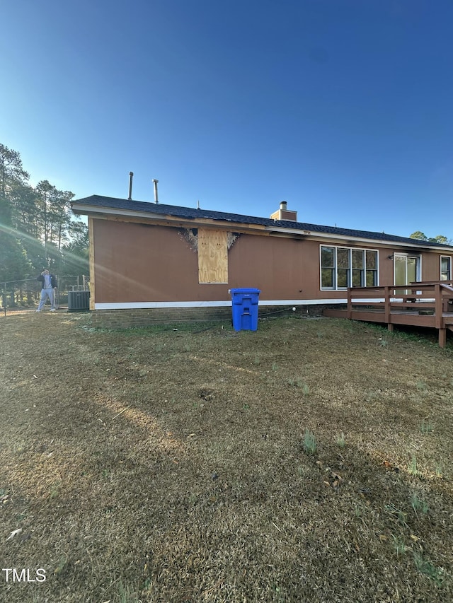 back of property featuring a deck and central air condition unit