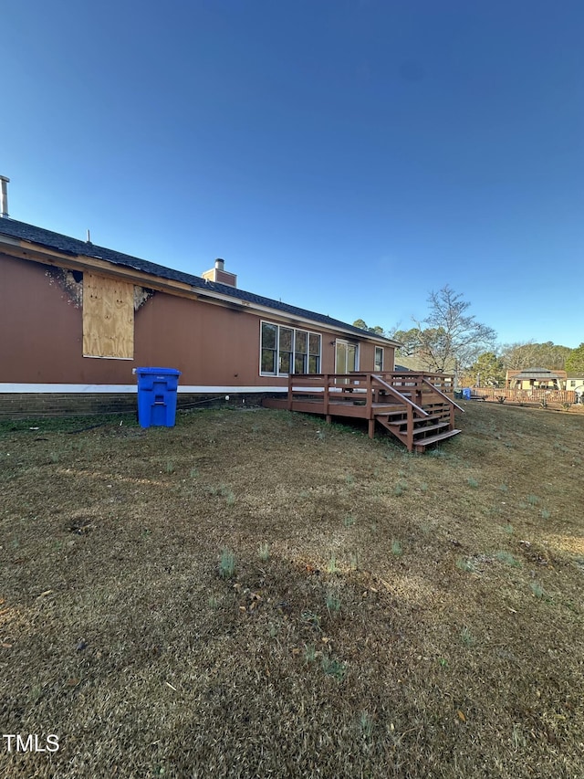 rear view of property featuring a deck