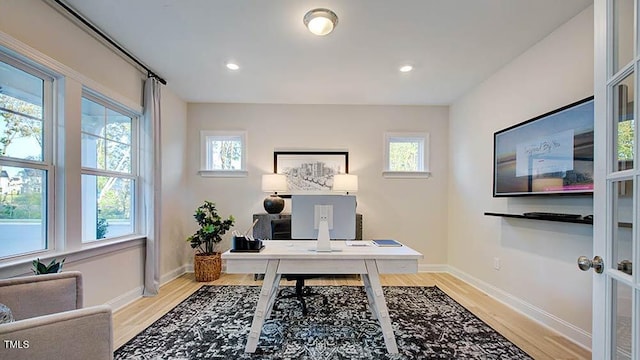 office featuring recessed lighting, light wood-type flooring, and baseboards