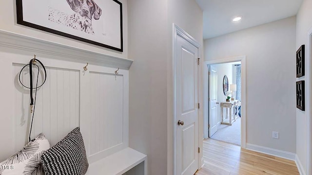 mudroom with light wood-style flooring, recessed lighting, and baseboards