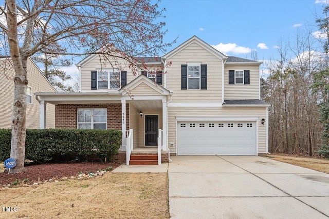 traditional-style house featuring a porch, a garage, brick siding, and driveway