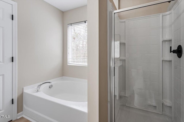 bathroom featuring a garden tub and a stall shower