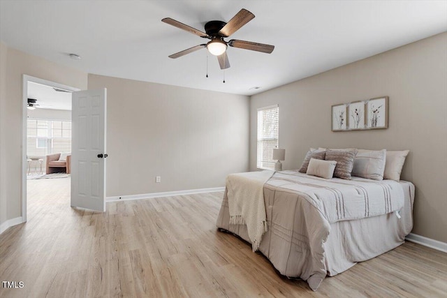 bedroom featuring light wood-style flooring, baseboards, and ceiling fan