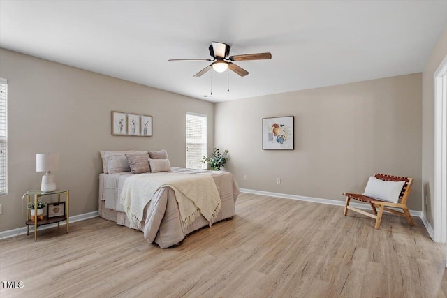 bedroom with light wood-type flooring, baseboards, and ceiling fan