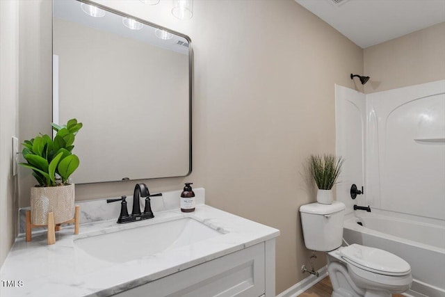 full bathroom featuring vanity, toilet, bathing tub / shower combination, and baseboards