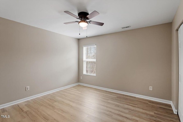 unfurnished room with visible vents, baseboards, light wood-style floors, and a ceiling fan