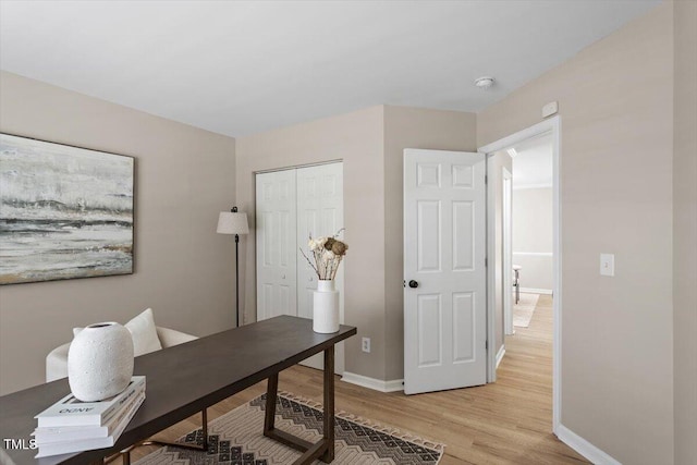 office area featuring light wood-style flooring and baseboards