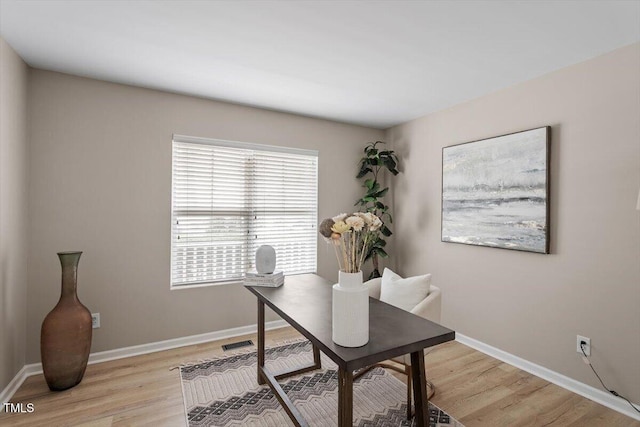 office space with visible vents, light wood-type flooring, and baseboards