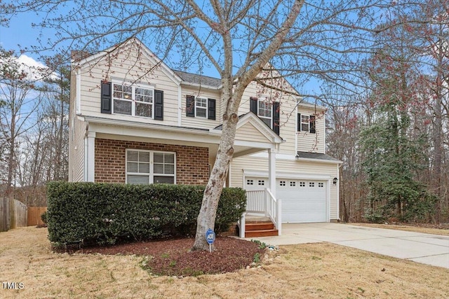 traditional-style home featuring concrete driveway, a garage, and brick siding