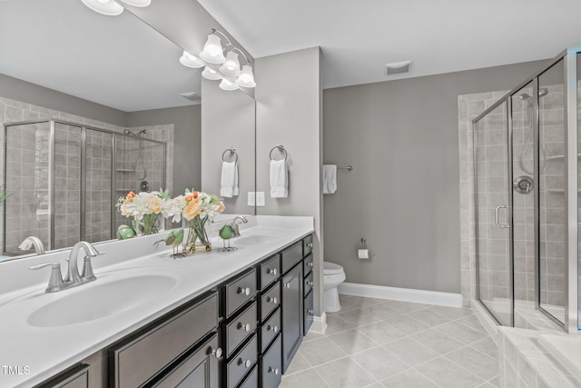 bathroom featuring tile patterned floors, a shower stall, baseboards, and a sink