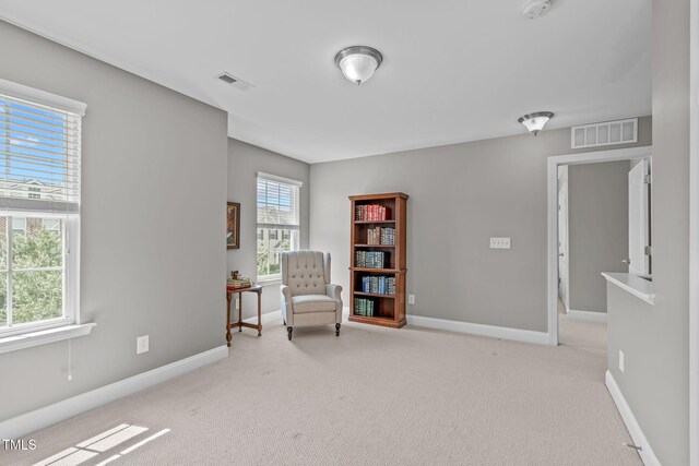 unfurnished room featuring carpet, baseboards, and visible vents