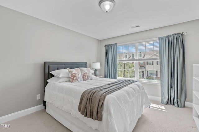 bedroom with visible vents, baseboards, and carpet flooring