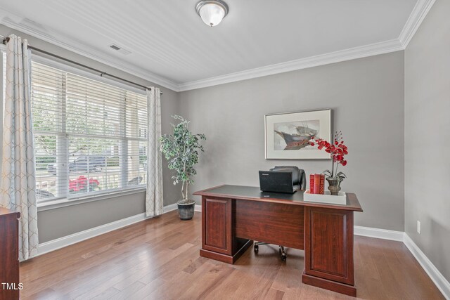 office area featuring visible vents, crown molding, baseboards, and wood finished floors