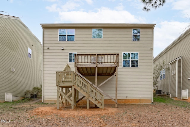 back of property with stairs, a deck, and cooling unit