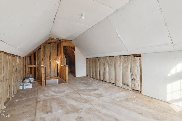 unfinished attic with an upstairs landing