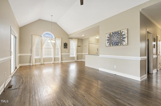 unfurnished living room with dark wood finished floors, baseboards, and lofted ceiling