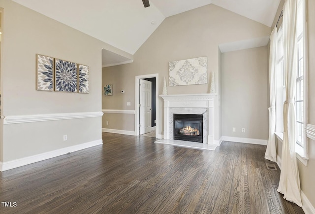 unfurnished living room with visible vents, baseboards, dark wood finished floors, a fireplace, and high vaulted ceiling