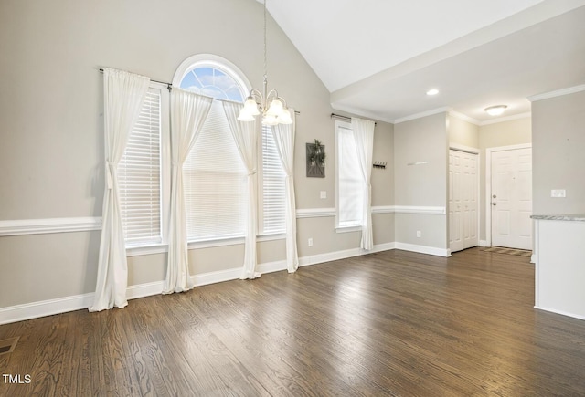 unfurnished room with baseboards, a notable chandelier, wood finished floors, and vaulted ceiling