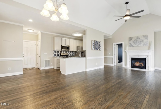 unfurnished living room with a sink, visible vents, dark wood finished floors, and ceiling fan with notable chandelier