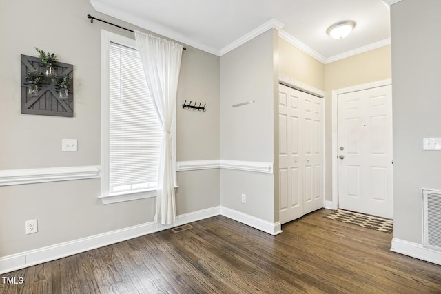 entrance foyer featuring visible vents, baseboards, dark wood-style flooring, and ornamental molding