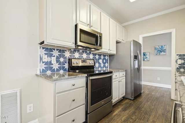 kitchen with visible vents, appliances with stainless steel finishes, white cabinets, and decorative backsplash