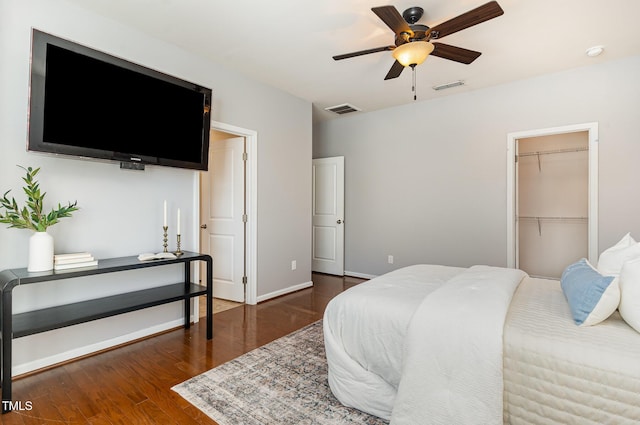 bedroom featuring a closet, visible vents, baseboards, and wood finished floors