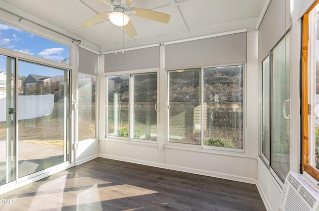 unfurnished sunroom with a ceiling fan and a wall mounted AC