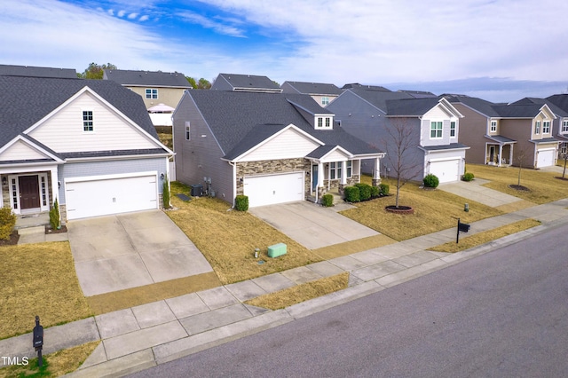 traditional home featuring a front yard, a residential view, and stone siding