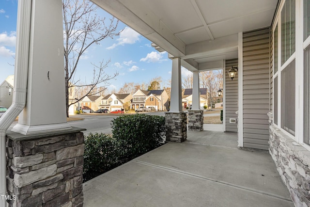 view of patio featuring covered porch and a residential view