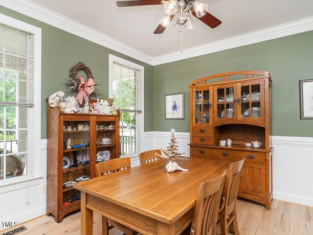 506 Wildwood Ln, Graham, NC 27253 - dining space featuring ornamental molding, wainscoting, ceiling fan, and light wood-type flooring