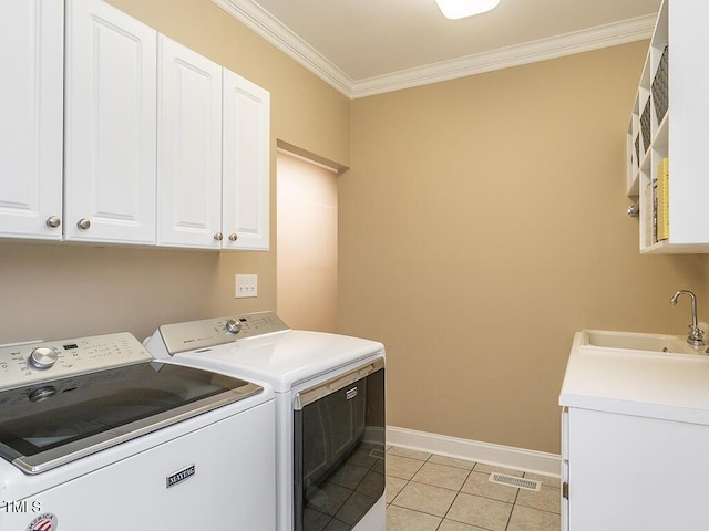 506 Wildwood Ln, Graham, NC 27253 - laundry area with cabinet space, washer and dryer, ornamental molding, baseboards, and light tile patterned floors