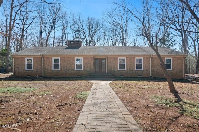 view of front of house with crawl space, brick siding, a chimney, and french doors