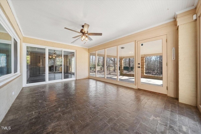 unfurnished sunroom with ceiling fan