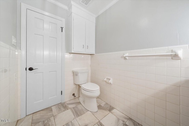 bathroom with visible vents, ornamental molding, wainscoting, tile walls, and toilet