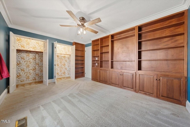 interior space featuring visible vents, crown molding, baseboards, light carpet, and a ceiling fan