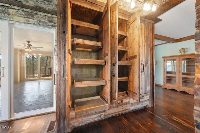 staircase featuring hardwood / wood-style floors, a ceiling fan, and visible vents